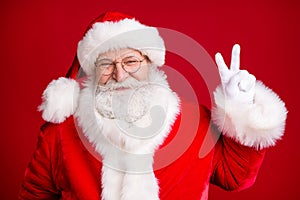 Photo of fairy santa claus make v-sign x-mas holly jolly party wear red costume white gloves isolated over bright shine