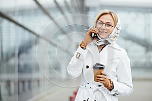 Photo of fashionable girl with beautiful brown hair smiling to c