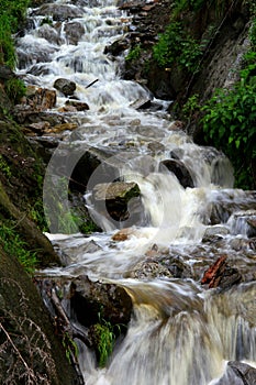 Photo of a fast-flowing full-water waterfall in Tirolo (Dorf Tirol), near Bolzano, Dolomites, Italy