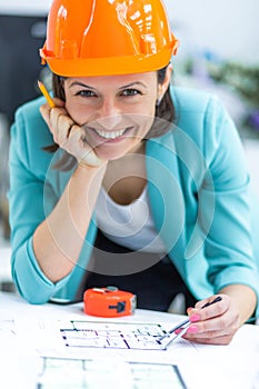 Photo of female engineer wearing orange helmet.