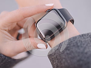 Photo of female hands touching setting of smart watch, close-up