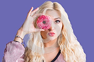 Photo of female holds sweet delicious doughnut