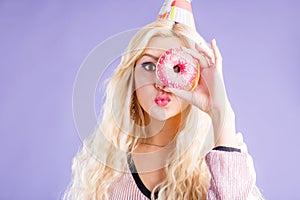 Photo of female holds sweet delicious doughnut