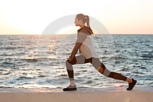 Photo of fit young woman doing stretching exercise