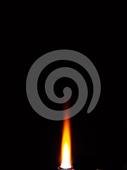 Photo of the flame of a gas burner torch on a black background