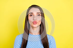 Photo of flirty charming young woman dressed blue clothes sending you kiss isolated yellow color background