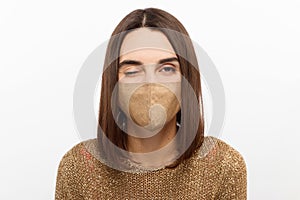 Photo of flirty young girl blink eye look camera wear face mask isolated white color background