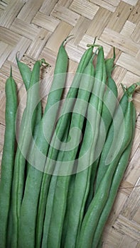 photo focusing on chickpeas on a woven bamboo background