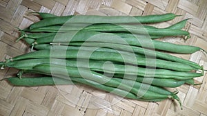 photo focusing on chickpeas on a woven bamboo background