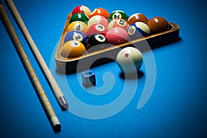 Photo fragment of the blue pool billiard game with cue. Pool billiard game. Billiard sport concept.play cue and