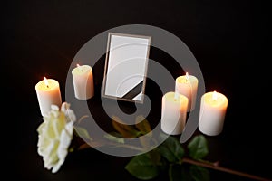 Photo frame with black ribbon, flower and candles