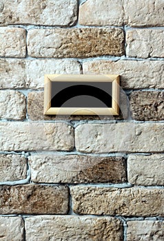 Photo frame on brick wall