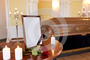 Photo frame and coffin at funeral in church