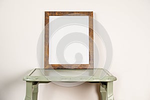 photo frame mock up on a green retro small table plain background