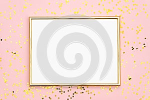 Photo frame mock up with space for text, golden sequins confetti on pink background. Lay Flat, top view. Valentine`s