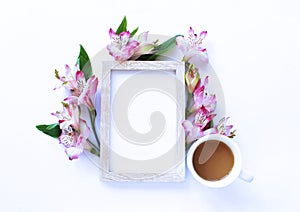 Photo frame, pink astromeria flowers and a Cup of coffee. photo