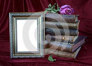 Photo frame and stack of antique books