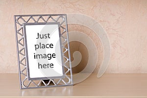 Photo frame on a wooden shelf