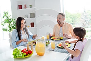 Photo of friendly cheerful people family harmony eat delicious dish chatting bright morning modern kitchen house inside