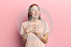 Photo of friendly positive woman touching her heart