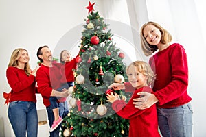 Photo of full big family five people meeting three little kids dad hold daughter boy hang toy decorate x-mas tree star
