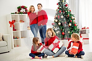 Photo of full big family five people meeting three little kids hold boxes ribbon bow guess present parents spectate near