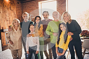 Photo of full family gathering eight people two little kids waiting blessing cheerful shiny beaming smile cuddle embrace