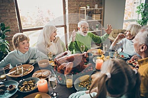 Photo of full family reunion gathering sit feast dishes chicken table communicating fall november autumn holiday multi photo