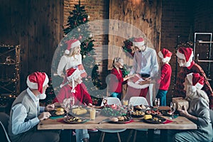 Photo of full harmony family gathering dinner table sharing x-mas presents getting out large santa pack red giftbox in