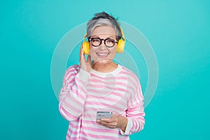 Photo of funky cool woman dressed pink pullover earphones enjoying melody modern gadget isolated teal color background