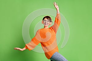 Photo of funky dreamy young woman dancer wear headset hipster good mood isolated on green color background