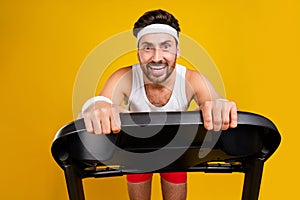 Photo of funky excited guy activewear having treadmill cardio training isolated yellow color background