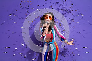 Photo of funky flirty lady wear striped overall dark glasses singing songs enjoying discotheque isolated purple color