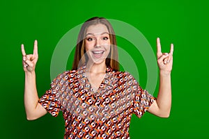 Photo of funky good mood adorable girl dressed print shirt hands showing rock symbol scream yeah isolated on green color