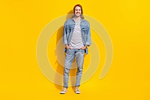 Photo of funky handsome nice guy with long hairstyle dressed jeans shirt standing hold arms in pockets isolated on