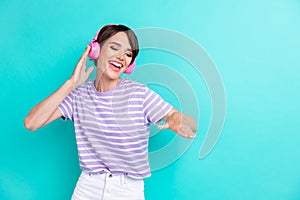 Photo of funky positive good mood woman with bob hairstyle dressed striped t-shirt dancing on party isolated on teal