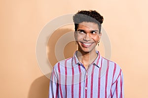 Photo of funky trendy young worker guy male wearing hipster piercing looking side isolated pastel beige color background