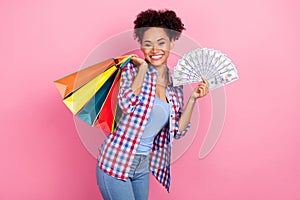 Photo of funky wavy hairdo lady hold bags money wear plaid shirt jeans isolated on pink color background
