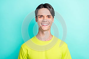 Photo of funky young brunet man wear yellow t-shirt isolated on turquoise color background