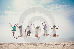 Photo of funny charming six young buddies dressed casual outfits rising arms jumping high outdoors countryside