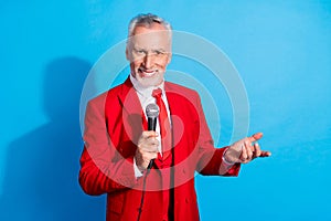 Photo of funny cheerful entertainer man hold microphone beaming smile wear red tux shoes isolated blue color background