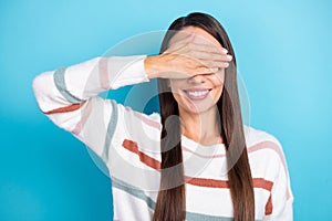 Photo of funny cheerful lady palm cover eyes anticipate holiday gift wear striped sweater isolated blue color background