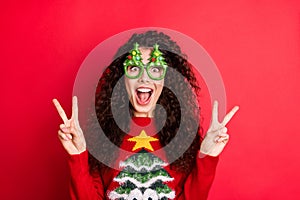Photo of funny curly lady ready for chilling showing v-sign symbols wear evergreen trees form specs and ugly ornament
