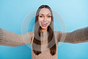 Photo of funny cute blogger lady take selfie lick lip wear beige pullover isolated blue color background