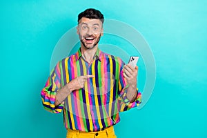 Photo of funny excited man brunet hair dressed striped shirt facebook twitter instagram whatsapp isolated on turquoise