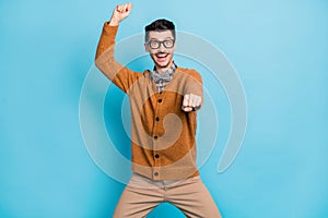 Photo of funny funky cool young guy happy ride cowboy wear glasses bow tie isolated on blue color background