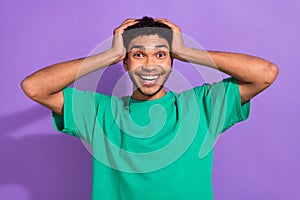 Photo of funny overjoyed youngster guy hold arms on head sale discount offer low prices shop isolated purple color