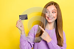 Photo of funny pretty lady stylish knitted jumper hand present bank card ebank emoney empty space isolated on yellow