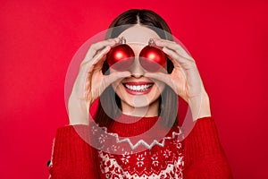 Photo of funny pretty young woman dressed print pullover smiling balls cover eyes isolated red color background