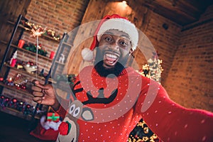 Photo of funny sweet dark skin man wear red sweater holding firework stick tacking selfie smiling indoors room home